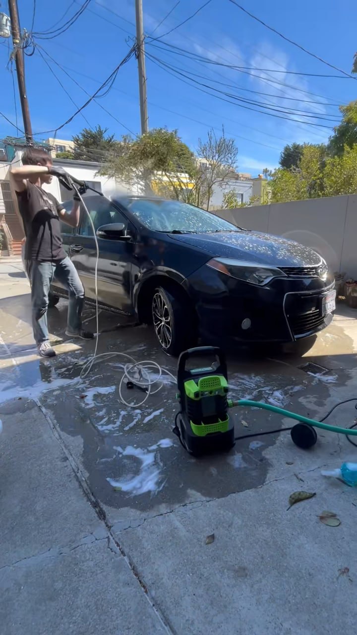 Alex washing a car on location in San Francisco